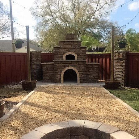 Firenze wood fired pizza oven built by Forno Nardona sits as a focal point in the backyard.