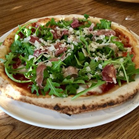 Gourmet pizza being served after having cooked in a wood-fired pizza oven made by Forno Nardona.