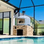 Forno Nardona Napoli Model Oven in blue moon blend glass tile with gas assist poolside.