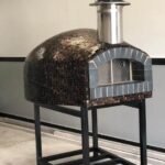 Forno Nardona Rustica custom brick dome pizza oven with back fire brick front on a custom stand.