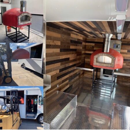 Red commercial Nardona pizza oven in a food truck on stand.
