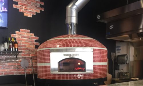 Commercial pizza oven by Forno Nardona in red and white tiles located at the Brick City Eatery in Lutz, Florida.
