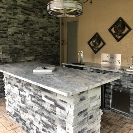 Forno Nardona Tampa built outdoor kitchen/bar made of stone, granite and Lion stainless accessories with island and personalized plate "Casa Summerelli" sign.