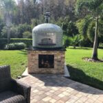 Forno Nardona Napoli pizza oven on custom Nardona base in travertine.
