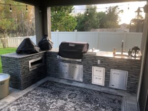 Stylish and sleek L-shaped Tampa built outdoor kitchen by Forno Nardona with Lion Premium BBQ products.
