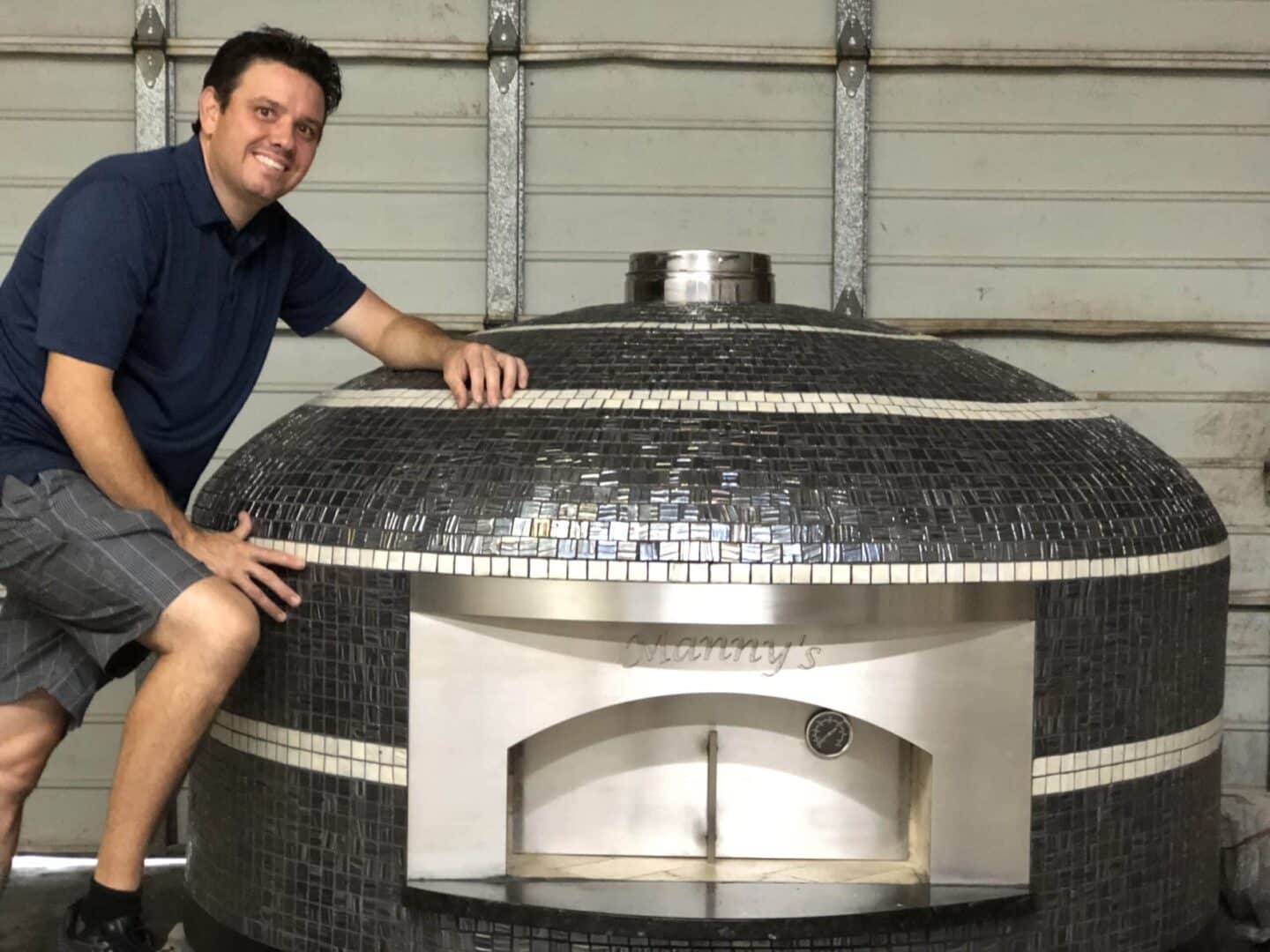 Pizza Oven Builder and Owner of Forno Nardona, William Hall poses with one of his Nardona Napoli pizza ovens.