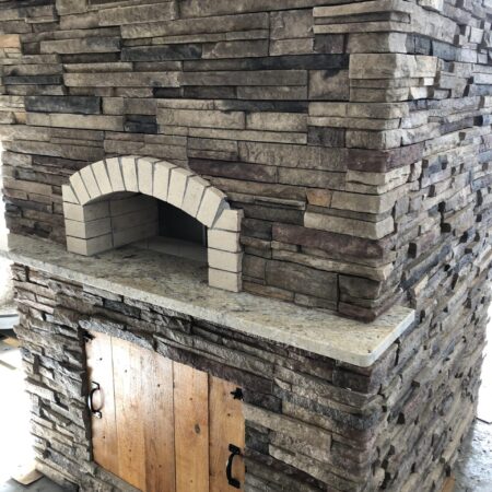 Forno Nardona Firenze Oven on a Nardona Base in Chardonnay Ledgestone with Wooden storage door.