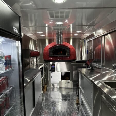 Interior of a pizza truck with a Red Nardona Rustica oven as the central focus.