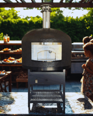 Napoli oven in Black Penny Tile with engraving Mangia Belle in an outdoor setting with a small girl looking on from the right.