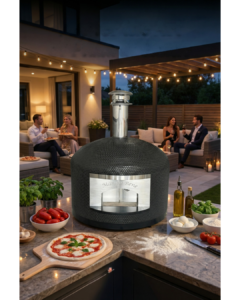 A Napoli pizza oven in the foreground and people relaxng in the background after a successful pizza evening. This is our most popular model of luxury pizza ovens.